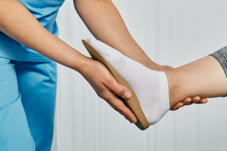 Orthopedist checking patient's foot