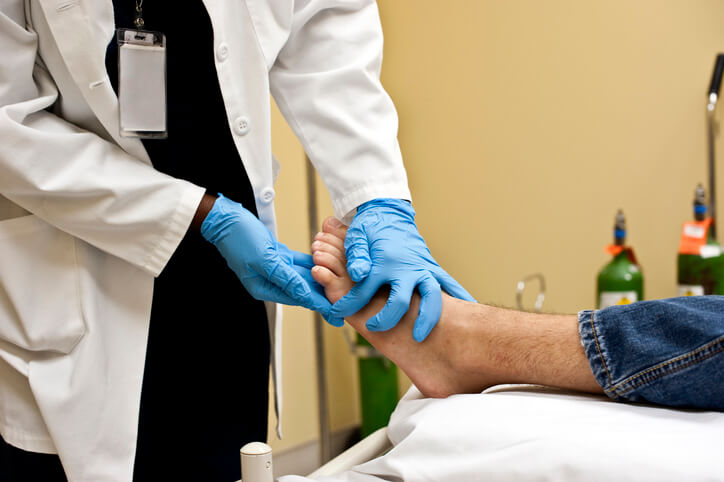 Orthopedic surgeon checking patient's foot